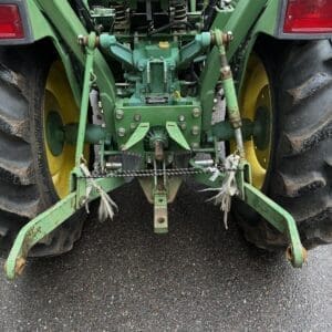 IMG_1386 - Montana Auctions by Kevin Hill Rear view of a green tractor showing three-point hitch, stabilizers, and chain between large tires.
