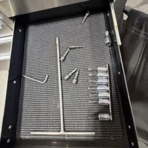 Open tool drawer with sockets, wrenches, and long metal rods; label reads 'Flat Screwdrivers'.