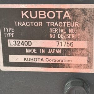 Metal identification plate on a Kubota tractor showing model L3240D, serial number 71756, Made in Japan (KUBOTA Corporation).