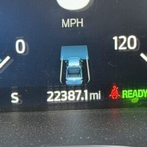 Instrument cluster shows the car at 223,871 miles with a blue icon of the vehicle and doors shown as open, READY indicator lit green to the right, and a red seatbelt warning nearby.