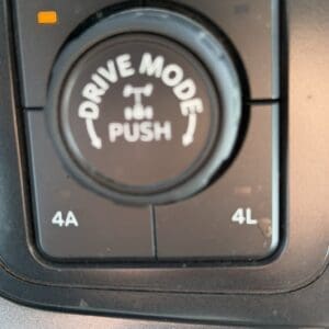 Drive mode selector knob in a vehicle with 2H and 4H/4A/4L indicators and an orange status light nearby