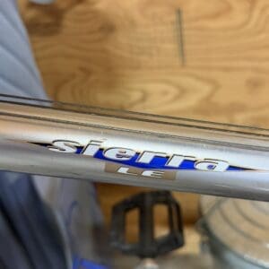 Silver bicycle frame with a blue stripe and the badge reading 'Sierra 18'