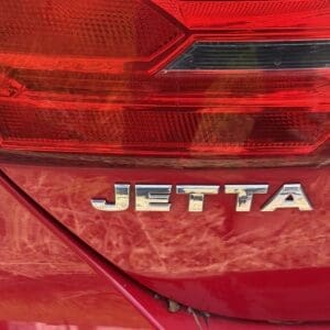 13 4 - Montana Auctions by Kevin Hill Red rear of a Volkswagen Jetta, featuring the chrome JETTA badge and red taillights