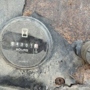 15 7 - Montana Auctions by Kevin Hill Dusty hour meter reading 4,301 hours on a corroded metal panel in dusty machinery environment.