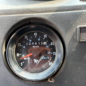 19 6 - Montana Auctions by Kevin Hill Close-up of a vehicle dashboard speedometer showing about 15 mph with an odometer reading around 224,615 miles and a small elephant emblem in the dial area.