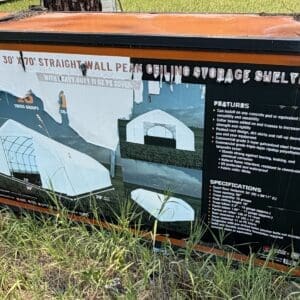 35 2 - Montana Auctions by Kevin Hill Product spec panel on an orange storage shelter showing diagrams and features for a 30'×70' straight-wall peak-ceiling shelter.