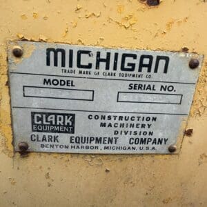 4 6 - Montana Auctions by Kevin Hill Weathered metal nameplate on yellow machinery: MICHIGAN brand with Clark Equipment Company and model/serial number; Benton Harbor, Michigan.