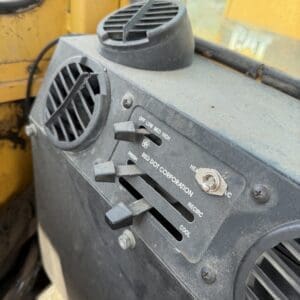 5 11 - Montana Auctions by Kevin Hill Close-up of a dusty vehicle heater/AC control panel with sliders labeled OFF, LOW, MED, HIGH and recirculation/fresh-air settings inside a cabin.